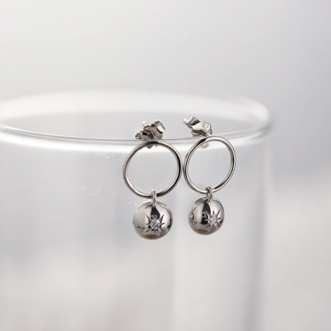 Sterling silver earrings with star embossing and zirconia stone