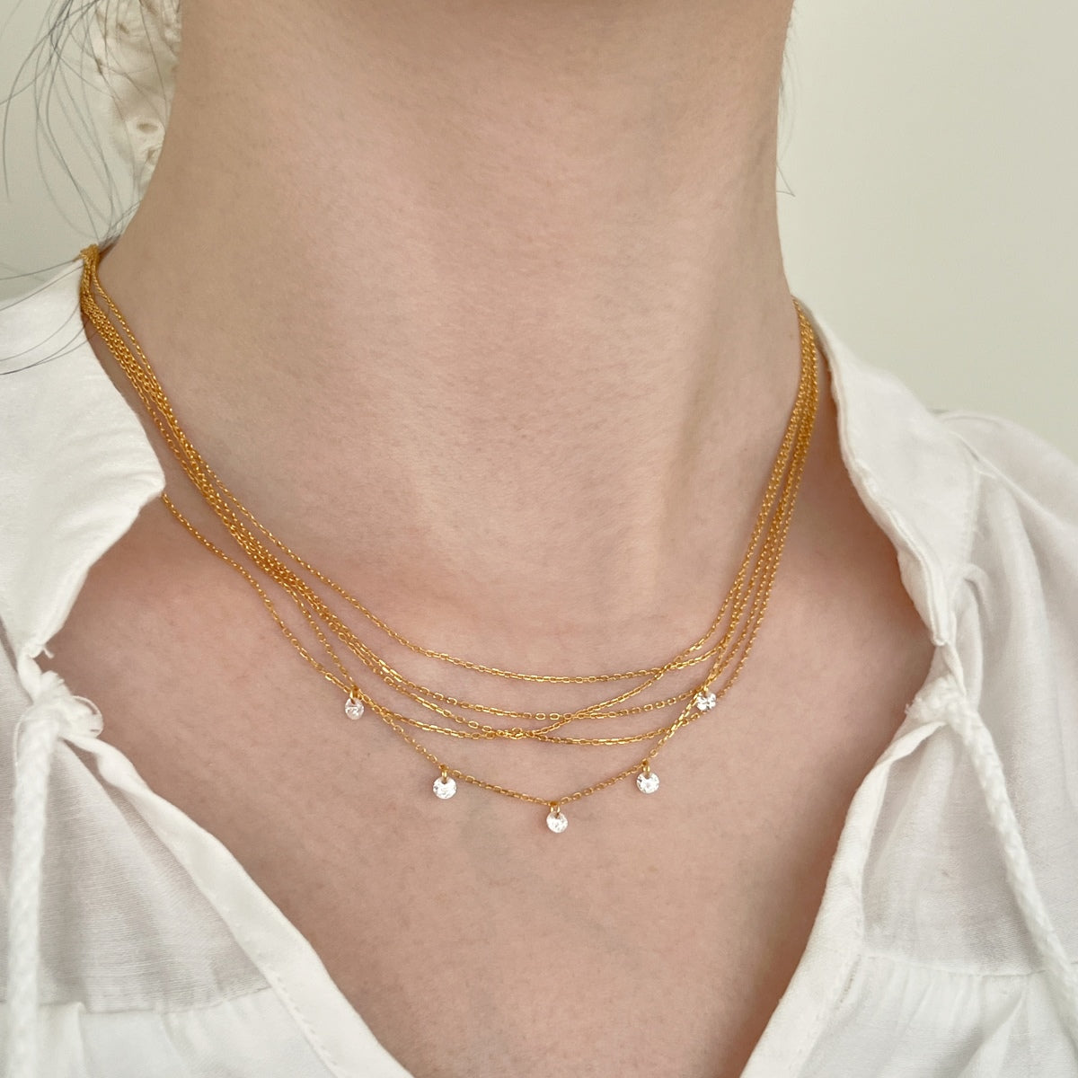Multi-row chain made of 925 sterling silver – 18K gold-plated with zirconia pendants