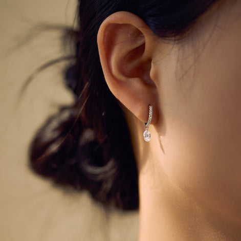 Hoop earrings made of 925 sterling silver with zirconia stones and oval pendant