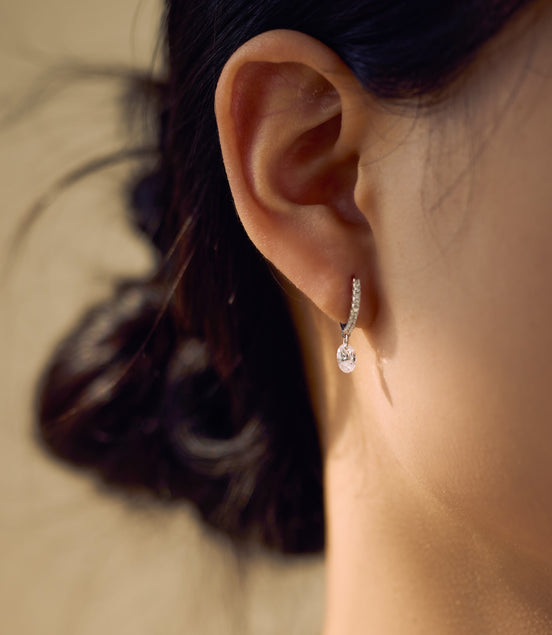 Hoop earrings made of 925 sterling silver with zirconia stones and oval pendant