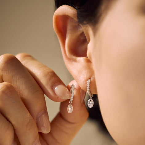 Hoop earrings made of 925 sterling silver with zirconia stones and oval pendant